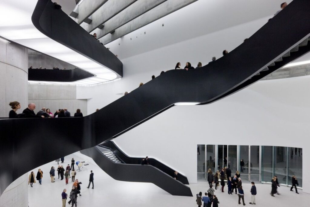 Black staircases and overlapping walkways in the atrium of the MAXXI in Rome, designed by Zaha Hadid