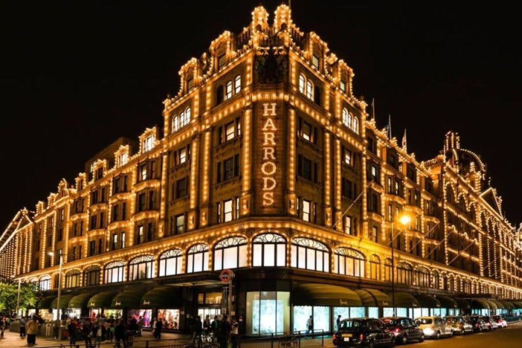 Harrods façade illuminated at night on Brompton Road in London