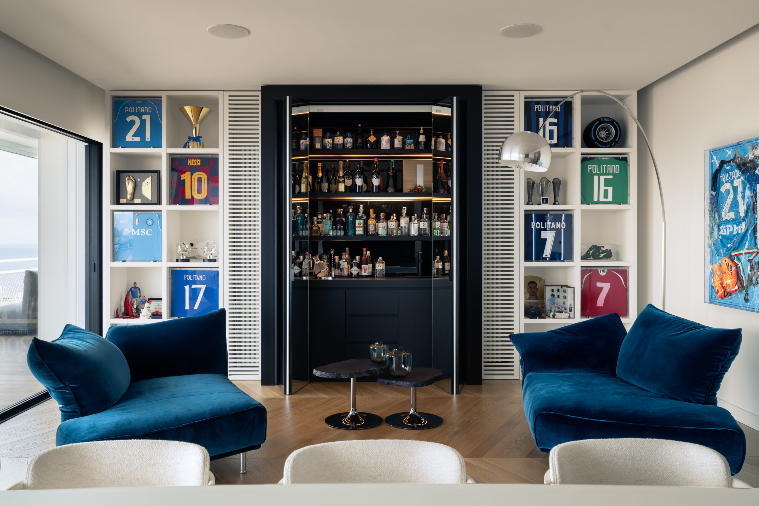 Living area at Casa AM in Naples with contemporary furniture and views across the Gulf, designed by OC16 Architects