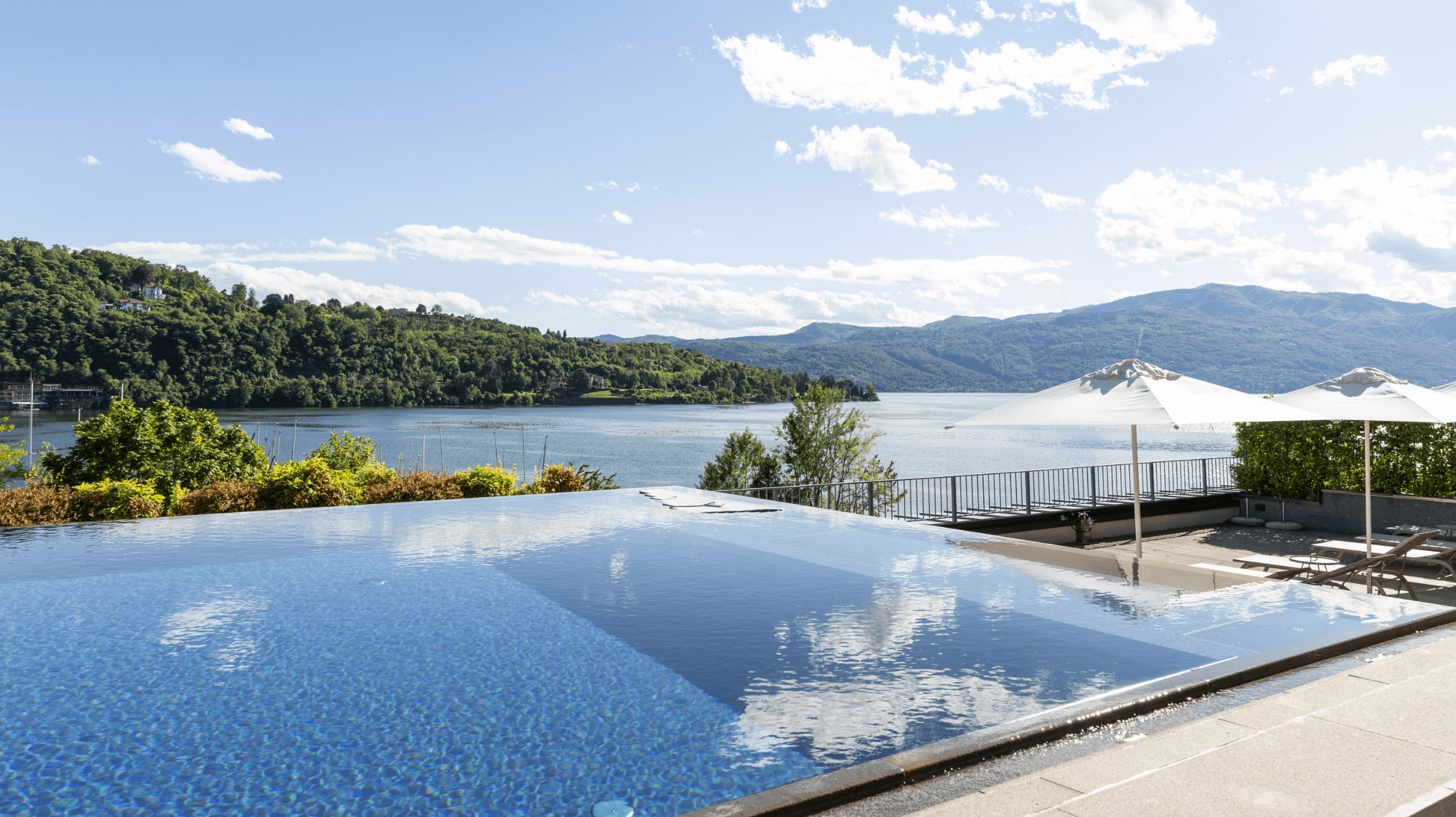 Infinity pool at Hotel de Charme Laveno overlooking Lake Maggiore and the mountains.
