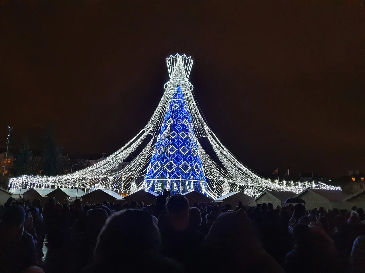 The Christmas tree in Cathedral Square in Vilnius with the bell tower behind
