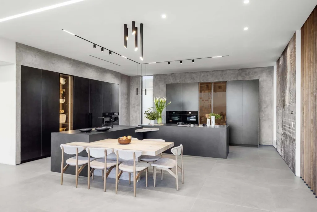 Kitchen with a dining area, broad floor surfaces and pale finishes