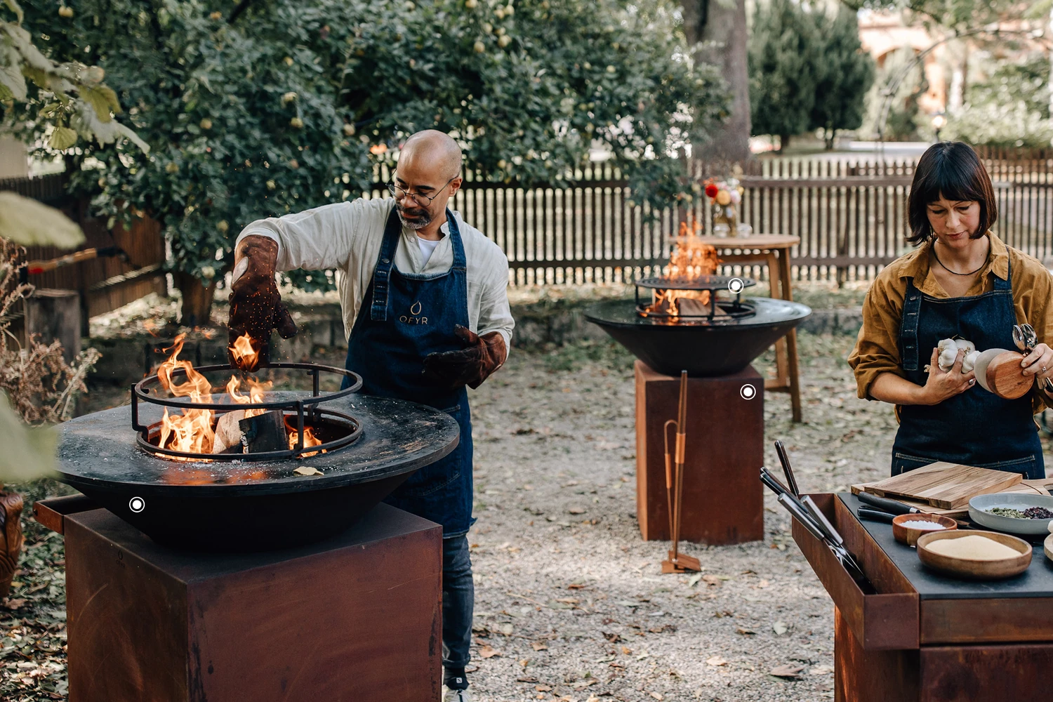 OFYR outdoor cooker being used in a furnished garden