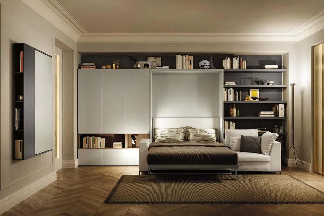 Double wall bed built into a bookcase wall with sofa