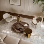 Bontempi living room seen from above with light fabric armchairs, a low round marble-effect coffee table and side tables with gold legs