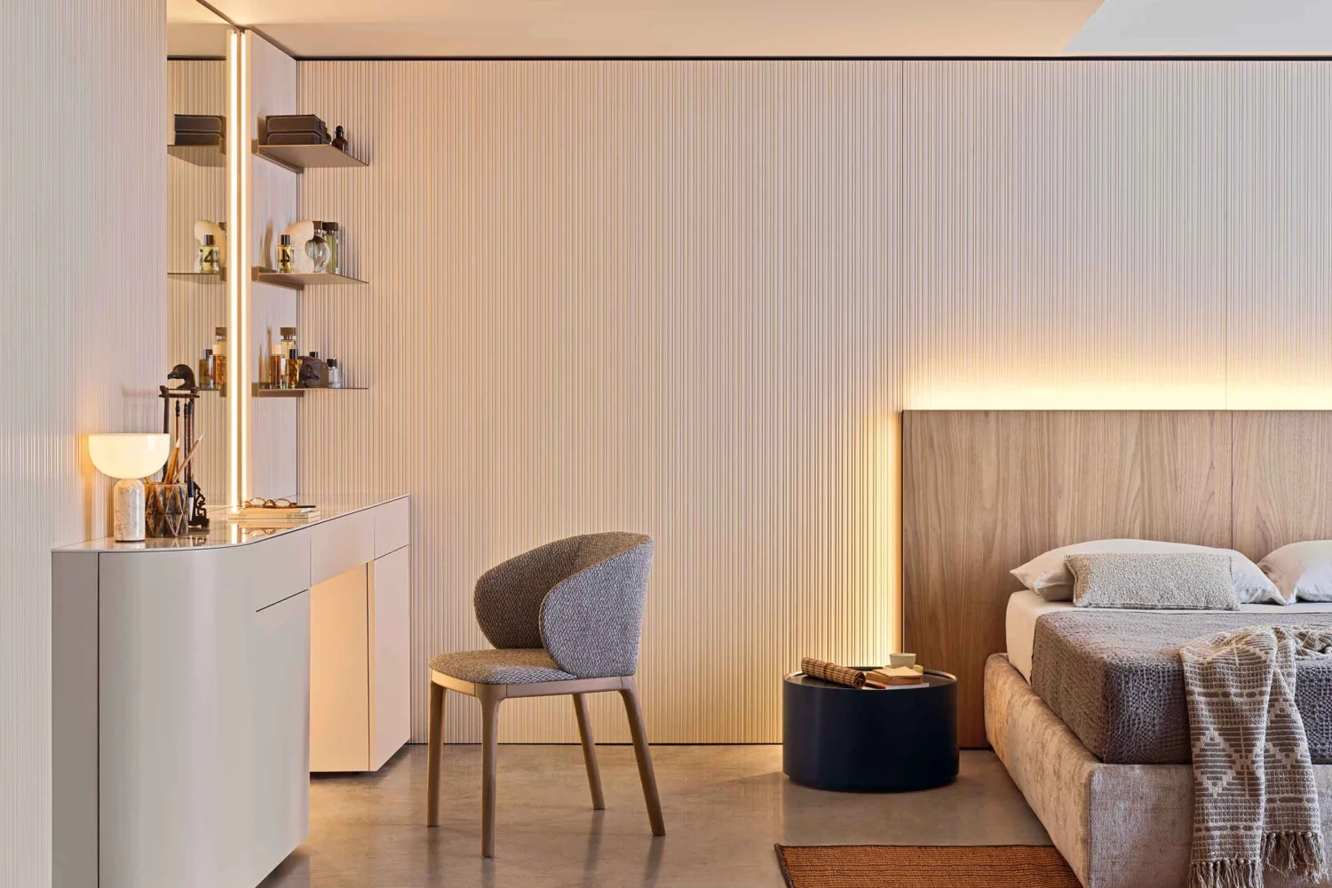 Bedroom with a pleated fabric wall, LED light in the headboard, white dressing table and illuminated shelves