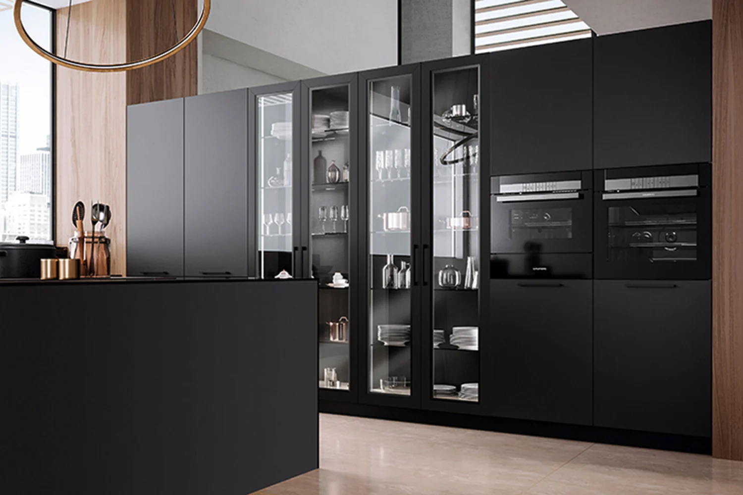 Matt black kitchen with tall units for built in ovens, lit glass cabinets and a dark island