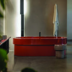 Red bathtub and washbasin in an Agape bathroom