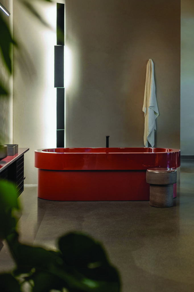 Red bathtub and washbasin in an Agape bathroom