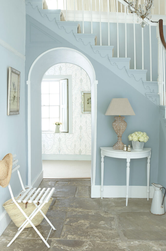Entrance with Bone China Blue walls, a staircase and a white console
