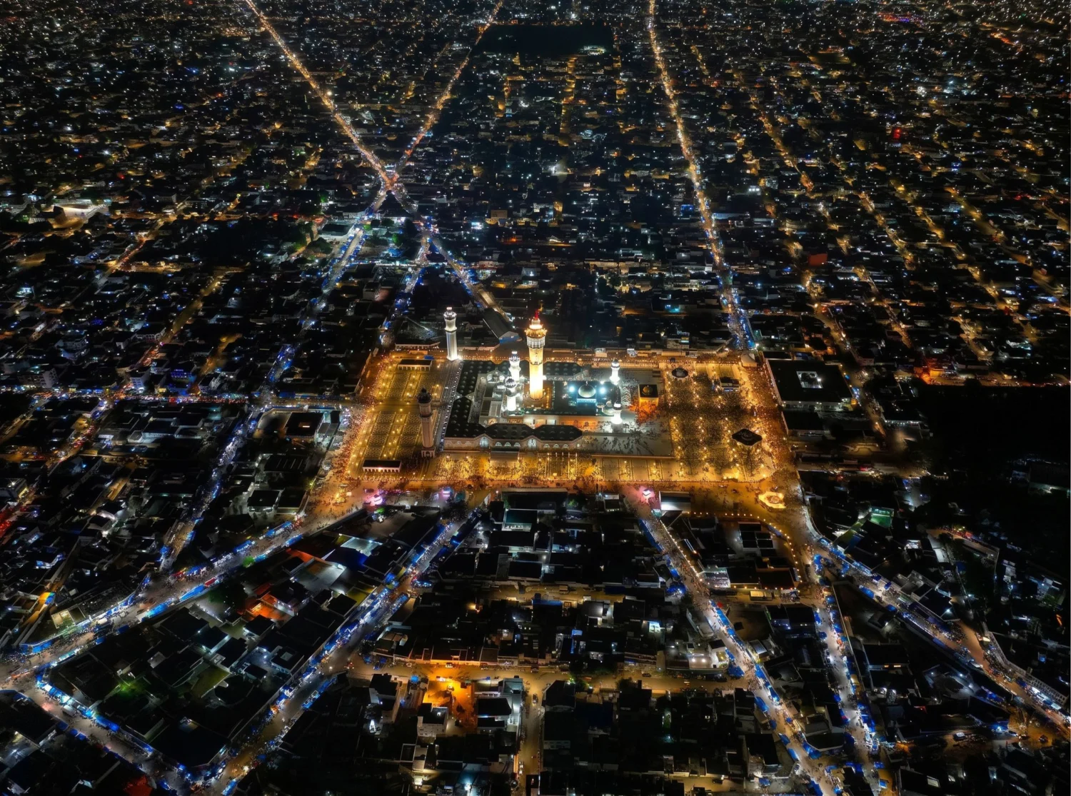 Night aerial view of the Great Mosque of Touba lit up at the centre of the city
