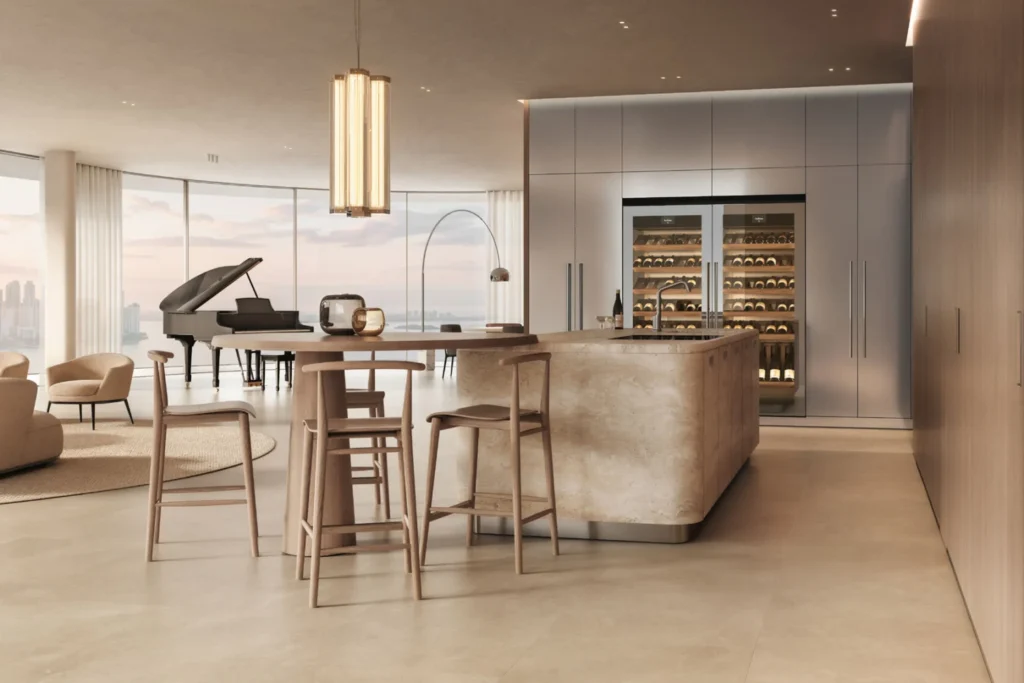 Cucina con isola rivestita e lanterna a sospensione in un open space con grandi vetrate