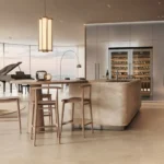 Cucina con isola rivestita e lanterna a sospensione in un open space con grandi vetrate
