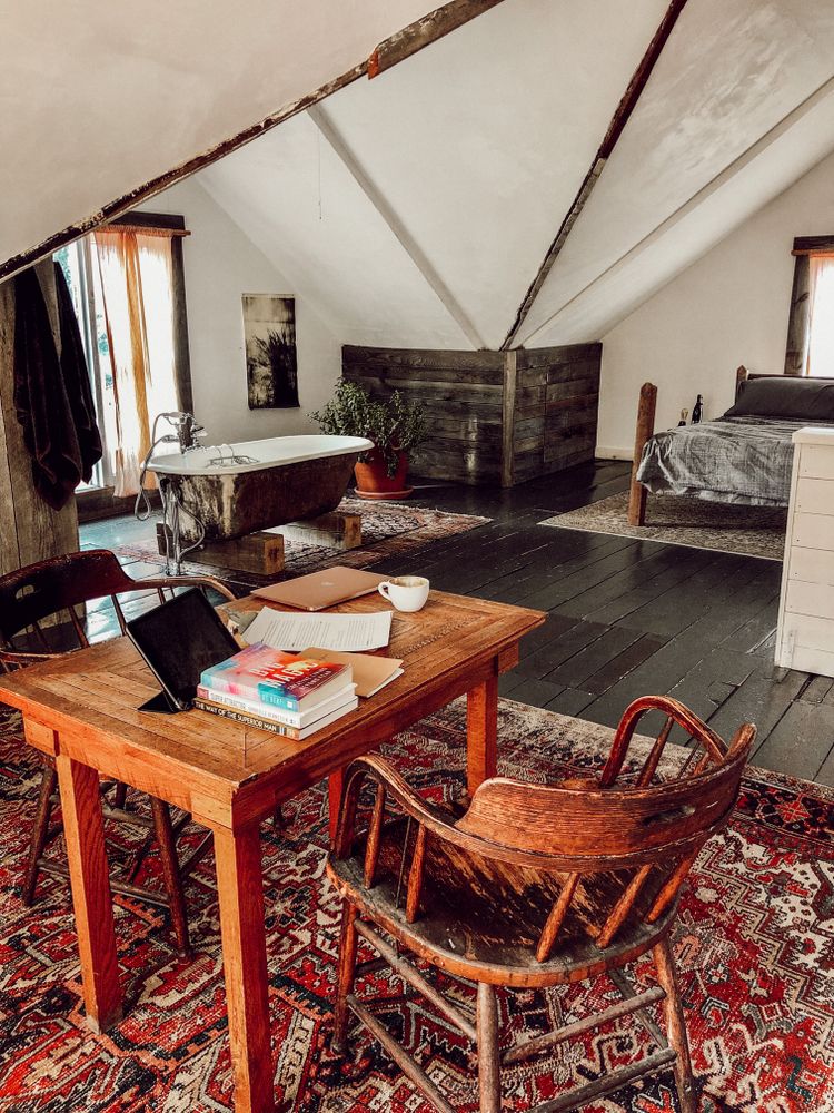 Study area in an attic with a sloping ceiling and natural light