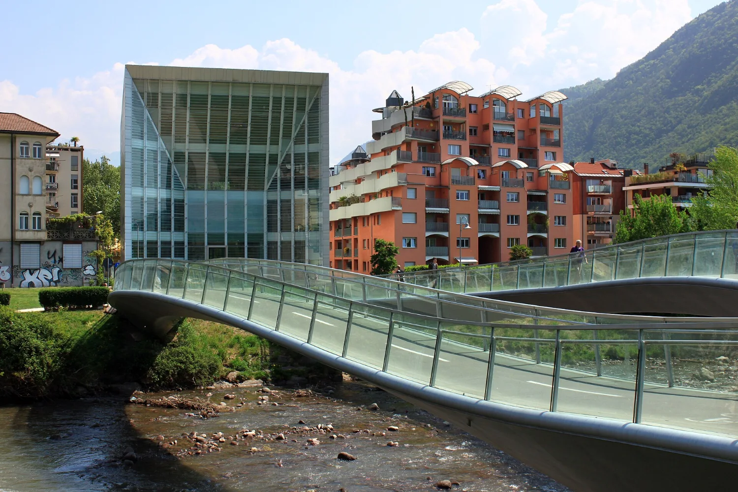 Museion in Bolzano with its glass façade and the bridge over the Talvera river