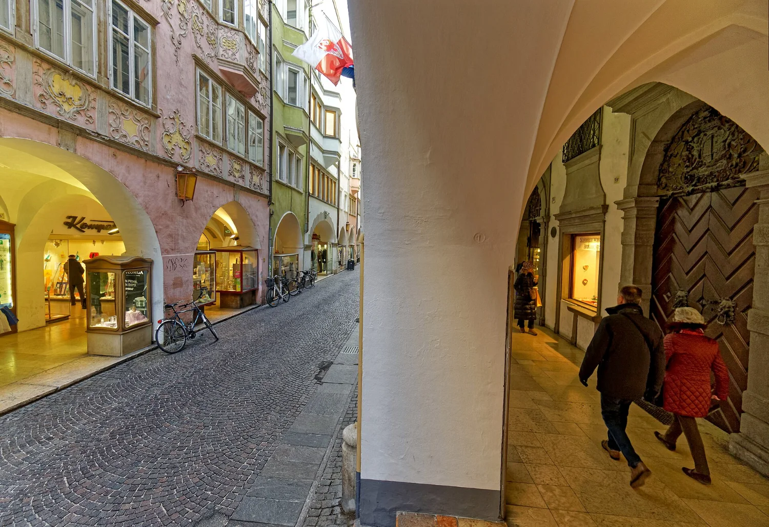 Via dei Portici in Bolzano with covered arcades and shop windows