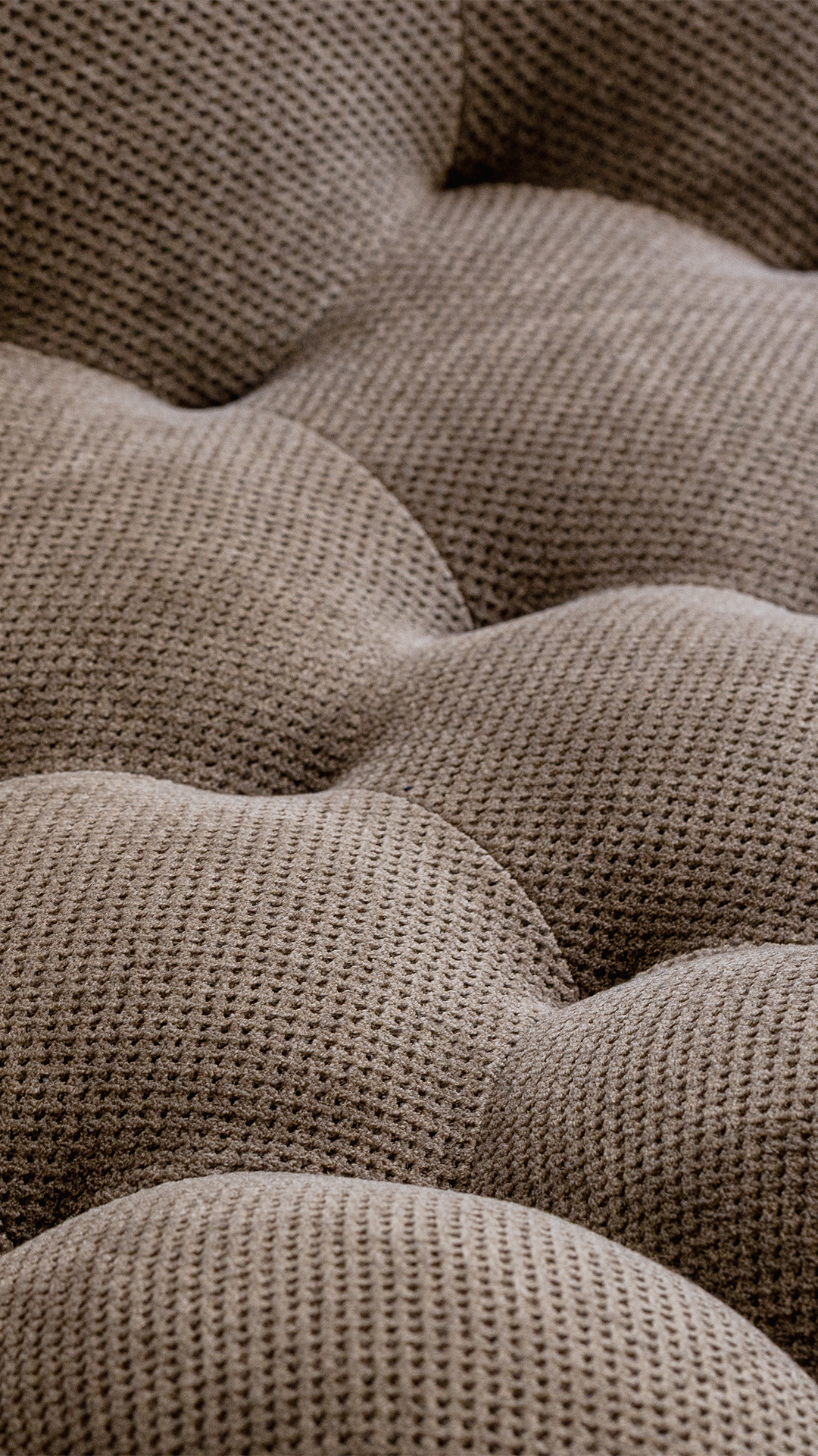 Rounded volumes and textured upholstery of a Roche Bobois Bubble sofa