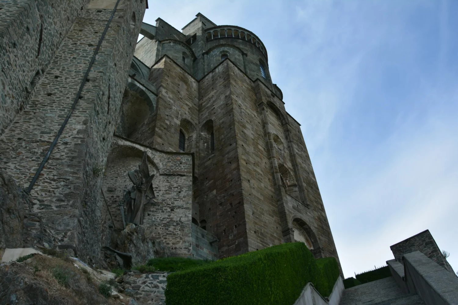 The stone apses of the church of the Sacra di San Michele seen from below