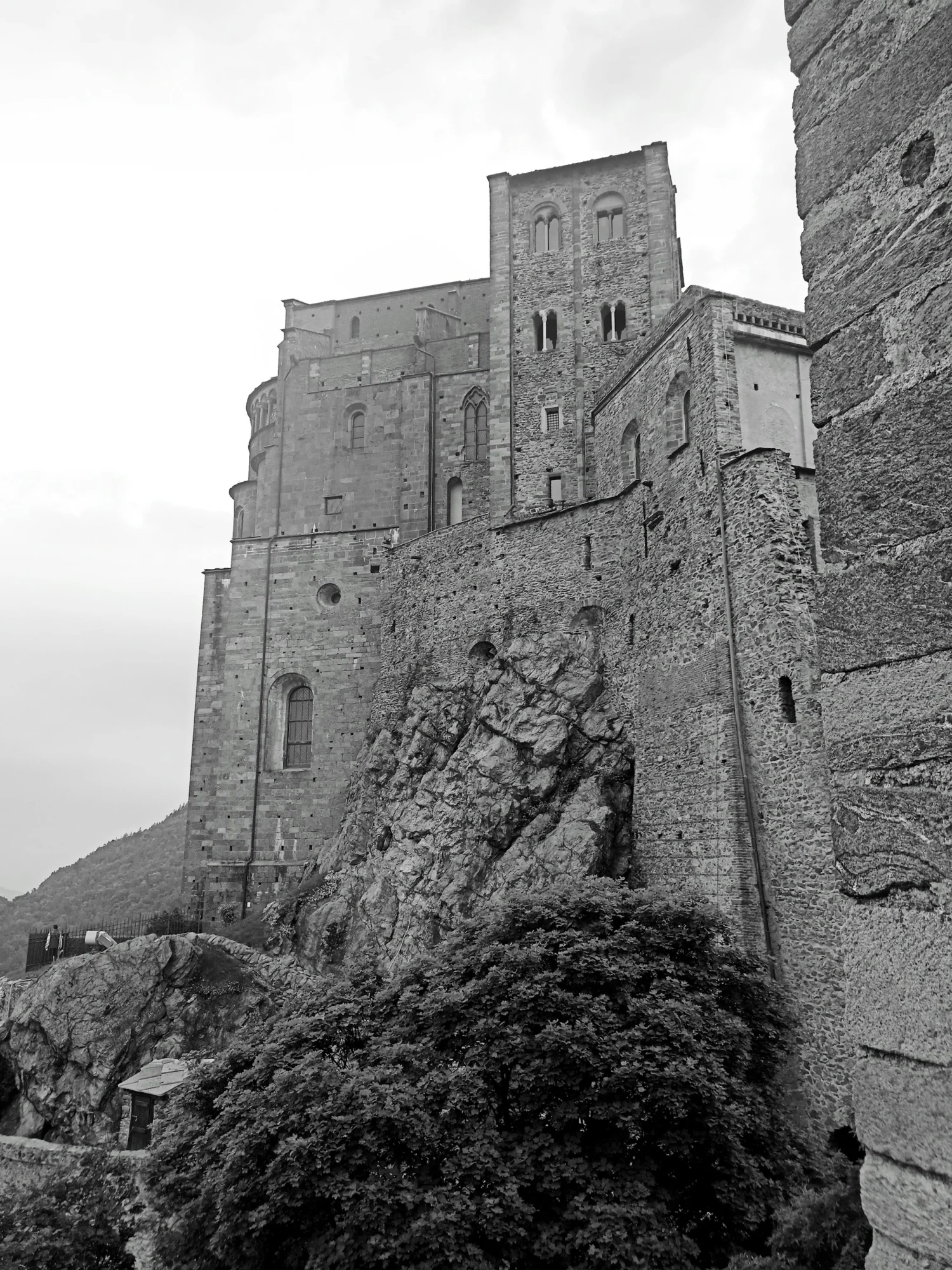 The stone base and apse mass of the Sacra di San Michele in black and white