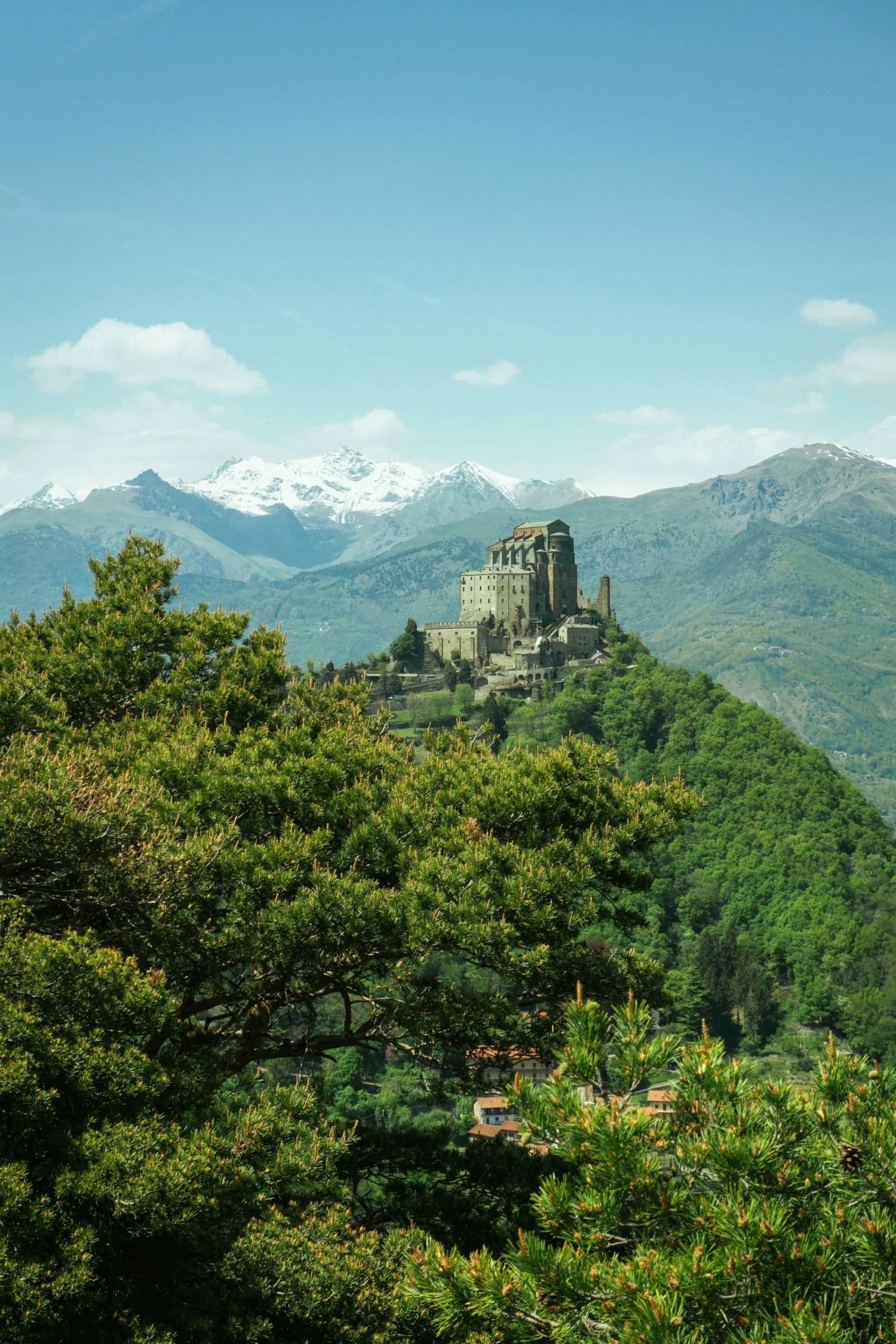 The Sacra di San Michele seen from afar among the woods of the Susa Valley